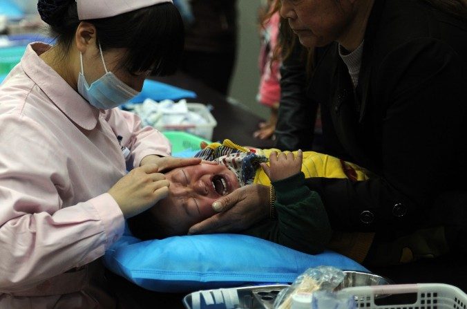 Esta imagen tomada el 5 de abril del 2013 muestra a un niño chino que consigue tratamiento para la gripe en un hospital en Hefei, provincia de Anhui, este de China. (STR / AFP / Getty Images)
