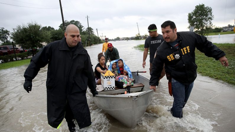 Una familia es evacuada de su hogar después de una grave inundación tras el paso del huracán Harvey el 29 de agosto de 2017 en Houston, Texas. (Win McNamee / Getty Images)
