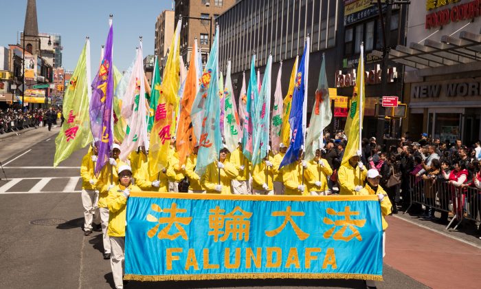 Los practicantes de la disciplina espiritual Falun Dafa, también conocida como Falun Gong, marchan en un desfile en Flushing, Nueva York, el 22 de abril de 2018. (Larry Dai/La Gran Época)