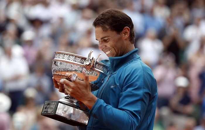 Rafael Nadal of Spain celebrates with the trophy after winning his 11th French Open title against Dominic Thiem of Austria during their men'Äôs final match during the French Open tennis tournament at Roland Garros in Paris, France, 10 June 2018. (España, Abierto, Abierto, Tenis, Francia) EFE/EPA/CHRISTOPHE PETIT TESSON