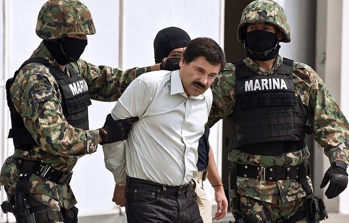El narcotraficante mexicano Joaquín Guzmán Loera alias "el Chapo Guzmán" (C), es escoltado por infantes de marina luego de ser arrestado, el 22 de febrero de 2014 en la Ciudad de México.  (RONALDO SCHEMIDT/AFP/Getty Images)