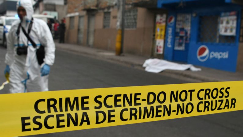 Personal forense trabaja en la escena donde una estudiante del Instituto Central Vicente Cáceres, fue asesinada a tiros por presuntos pandilleros, cuando se dirigía a clase en Tegucigalpa el 13 de abril de 2018. (ORLANDO SIERRA/AFP/Getty Images) 
SIERRA/AFP/Getty Images)