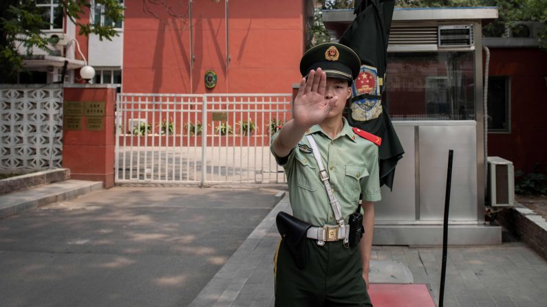 Un oficial de policía paramilitar hace un gesto ante la embajada de Bélgica en Beijing, China el 19 de junio de 2019. (NICOLAS ASFOURI/AFP/Getty Images)