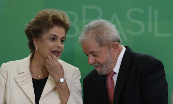 O ex-presidente do Brasil, Luiz Inácio Lula da Silva, conversa com a então presidente do Brasil, Dilma Rousseff, enquanto ele assume o cargo de novo chefe de gabinete do Palácio do Planalto em 17 de março de 2016, em Brasília, Brasil (Igo Estrela / Getty Images)