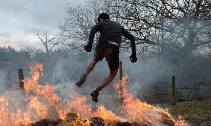 Un competidor se abre paso a través del fuego en una prueba de resistencia Tough Guy en Inglaterra, el 27 de enero de 2019. (Oli Scarff/AFP/Getty Images)