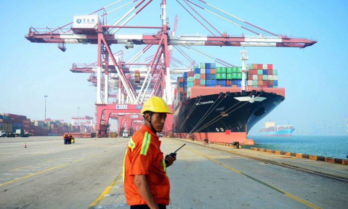 Un trabajador chino en un puerto de Qingdao, China, el 13 de julio de 2017. Los chinos son un obstáculo para el libre comercio y el presidente Trump está utilizando métodos arriesgados para resolver el problema. (STR/AFP/Getty Images)
