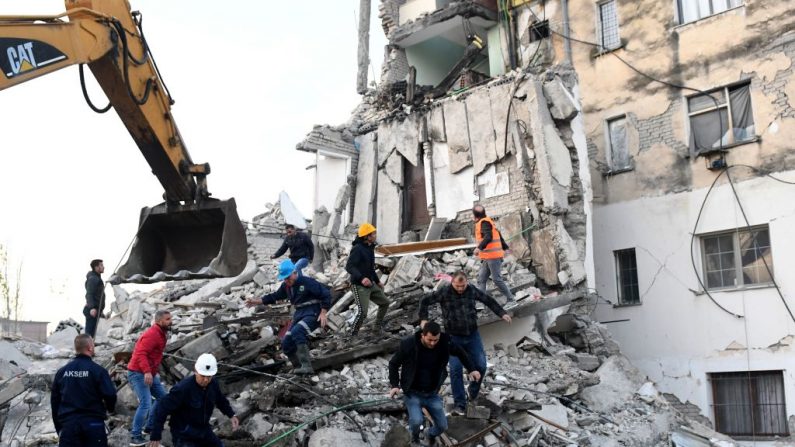 Los trabajadores de emergencia limpian los escombros en un edificio dañado en Thumane, 34 kilómetros (aproximadamente 20 millas) al noroeste de la capital, Tirana, después de un terremoto en Albania, el 26 de noviembre de 2019. (Gent Shkullaku/AFP via Getty Images)
