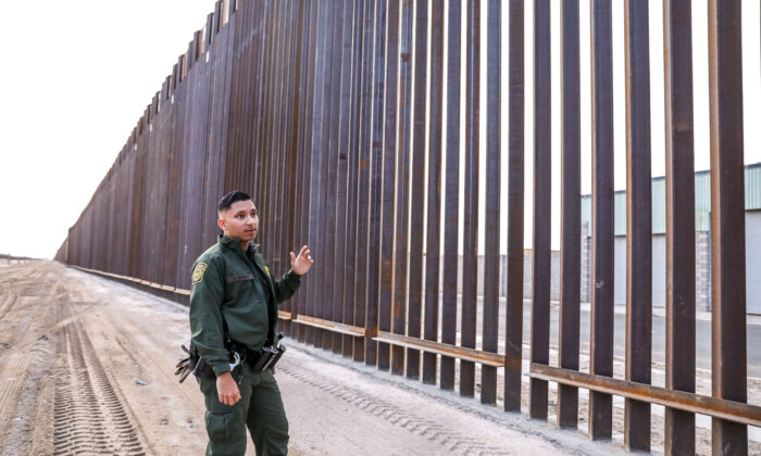 El agente de la Patrulla Fronteriza José Girabay se para al lado del nuevo muro de 30 pies de alto y 22 millas en la frontera entre México y los Estados Unidos al este de San Luis en Yuma, Arizona, el 27 de noviembre de 2019. (Charlotte Cuthbertson/The Epoch Times)