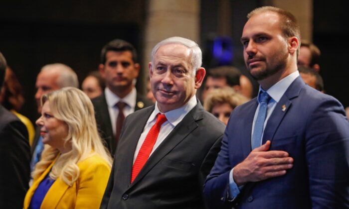 El primer ministro israelí Benjamin Netanyahu asistió junto con su esposa Sara y el diputado federal brasileño Eduardo Bolsonaro (dcha.) a la ceremonia de inauguración de la Agencia Brasileña de Promoción de Exportaciones e Inversiones en Jerusalén, el 15 de diciembre de 2019. (GIL COHEN-MAGEN/AFP vía Getty Images)