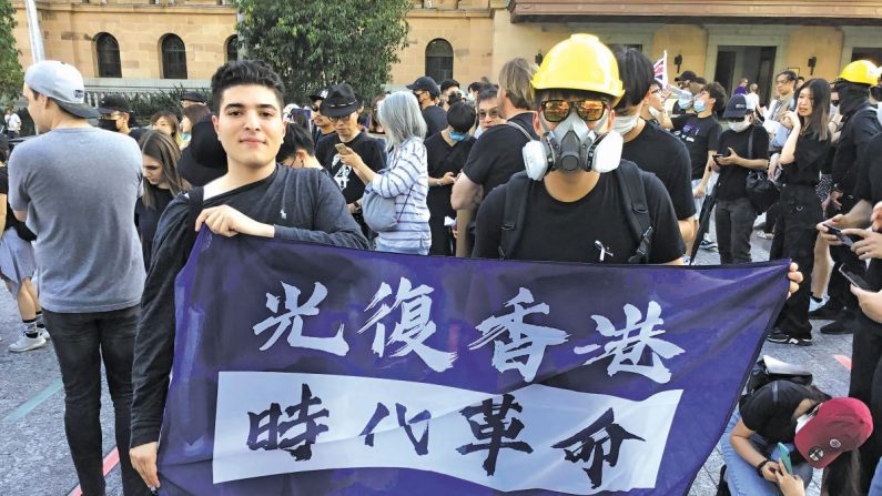 Drew Pavlou (izquierda), de 20 años, en una protesta con una pancarta que dice "Liberen a Hong Kong, la revolución de nuestros tiempos". (Cortesía de Drew Pavlou)