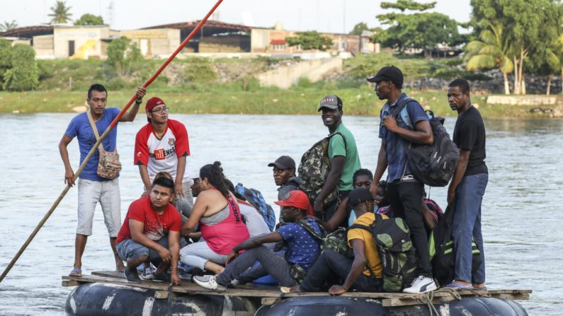 Un grupo de 10 haitianos cruza ilegalmente el río Suchiate en una balsa tubular desde Tecun Uman, Guatemala, hasta la ciudad de Hidalgo, México, el 28 de junio de 2019. Se dirigen a los Estados Unidos. (Charlotte Cuthbertson/The Epoch Times)