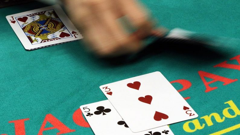 Un croupier demuestra cómo jugar al blackjack en una exposición de ocio en Tokio el 27 de noviembre de 2014. (YOSHIKAZU TSUNO/AFP a través de Getty Images)