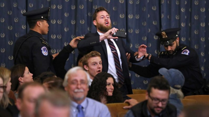 El presentador de Infowars, Owen Shroyer, grita mientras es expulsado por la policía después de interrumpir una audiencia del Comité Judicial de la Cámara de Representantes sobre el juicio político en el edificio de oficinas de Longworth House en Capitol Hill, Washington, el 9 de diciembre de 2019. (Chip Somodevilla/Getty Images)