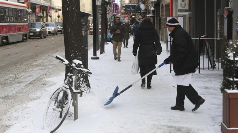 Un hombre remueve la nieve que está frente a su tienda en una calle de Toronto, la mayor ciudad de Canadá, donde la temperatura alcanzó los 25 grados bajo cero, el martes 22 de enero de 2013. EFE/Gloria Nieto Montero/Archivo