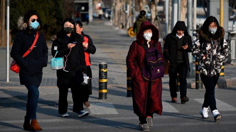 Los peatones con máscaras cruzan una calle en Beijing, China, el 21 de enero de 2020. (WANG ZHAO / AFP / Getty Images)