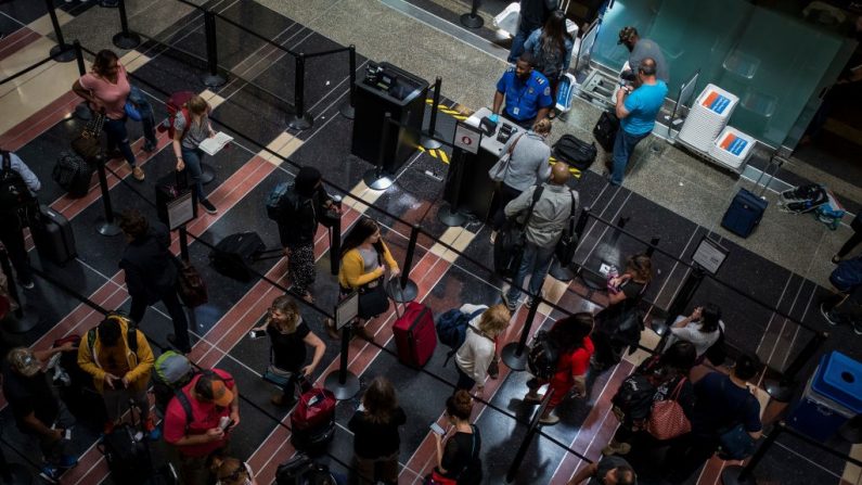 Imagen de archivo de pasajeros haciendo fila para pasar por un control de seguridad en el Aeropuerto Nacional Ronald Reagan el 24 de mayo de 2019 en Arlington, Virginia. (Foto de Zach Gibson/Getty Images)