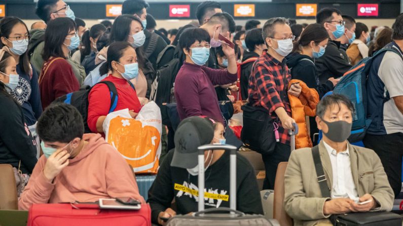 Los viajeros con mascarilla esperan en la sala de embarque de la estación West Kowloon el 23 de enero de 2020 en Hong Kong, China.  (Anthony Kwan / Getty Images)