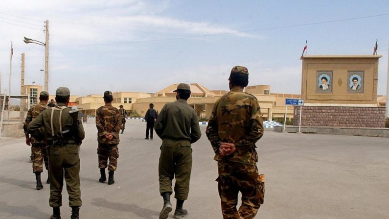Los guardias fronterizos iraníes se alejan del puesto fronterizo de Munthriya, cerca de la ciudad iraquí de Janaqin, situada al noreste del país. El puesto fronterizo de Al-munthriya, considerado el principal punto de paso entre el Iraq y el Irán en la provincia de Diyala, en el este del Iraq, está bajo el control exclusivo de la policía de fronteras iraquí desde el 26 de septiembre de 2003. Las imágenes del Ayatolá Khomeini (arriba a la izquierda) y del Ayatolá Khameini (arriba a la derecha), pueden verse al fondo.  Imagen de archivo del 12 de octubre de 2003. (ROBERTO SCHMIDT/AFP a través de Getty Images)