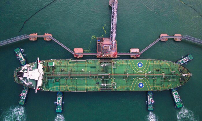 Esta foto aérea tomada el 4 de agosto de 2019 muestra remolcadores atracando un petrolero en el puerto de Qingdao, en la provincia de Shandong, China. (STR/AFP vía Getty Images)