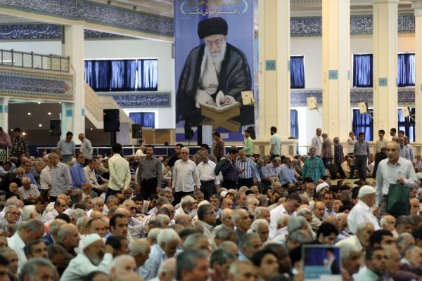 Fiéis iranianos participam das orações semanais de sexta-feira na mesquita Imam Khomeini na capital, Teerã, em 19 de julho de 2019. O cartaz por trás deles mostra o líder supremo do Irã, o aiatolá Ali Khamenei (STR / AFP / Getty Images)