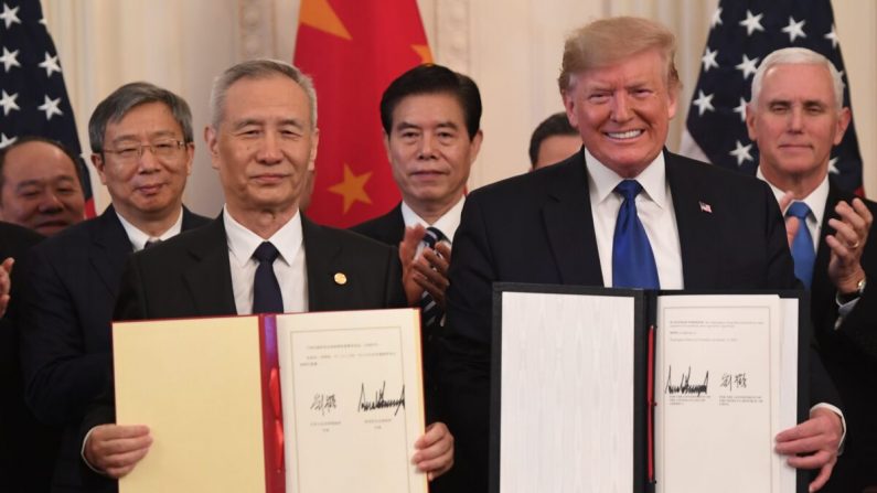 El viceprimer ministro chino Liu He y el presidente de Estados Unidos Donald Trump muestran el acuerdo comercial firmado entre Estados Unidos y China en el Salón Este de la Casa Blanca en Washington, D.C., el 15 de enero de 2020. (Saul Loeb/AFP vía Getty Images)