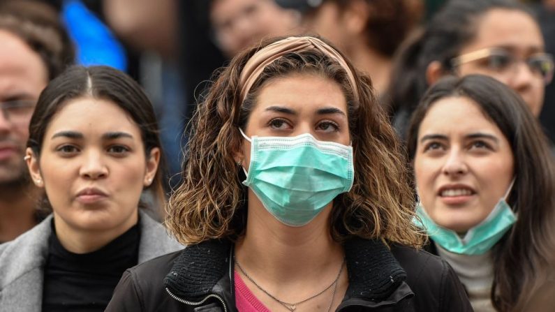 Turistas con máscaras respiratorias de protección esperan en la Plaza de San Pedro en el Vaticano. (Foto de Andreas SOLARO / AFP) 