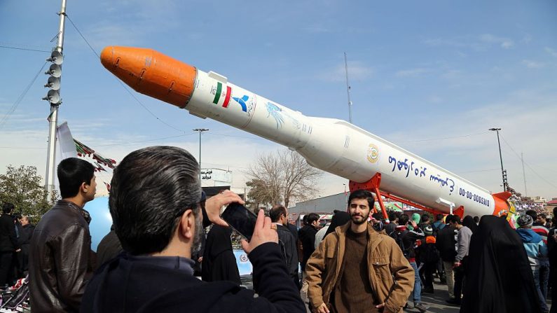 Los iraníes toman fotos del cohete satélite Simorgh (Phoenix) durante las celebraciones en Teherán para conmemorar el 37º aniversario de la revolución islámica el 11 de febrero de 2016. Los iraníes también agitaron banderas de "Muerte a América" (ATTA KENARE/AFP a través de Getty Images)