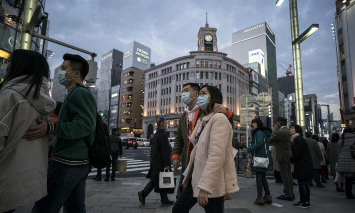 Turistas chinos con máscaras caminan por el distrito comercial de Ginza en Tokio, Japón, el 24 de enero de 2020. (Tomohiro Ohsumi/Getty Images)
