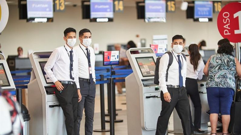 Personal de los terminales del Aeropuerto Internacional Jorge Chavéz utilizan tapabocas como medida de protección  en Lima. EFE/ Christian Ugarte
