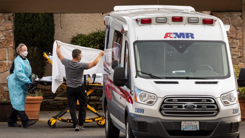 Trabajadores de la salud transportan a un paciente en camilla a una ambulancia en el Life Care Center de Kirkland en Kirkland, Washington, el 29 de febrero de 2020. (David Ryder/Getty Images)