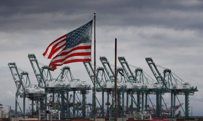 La bandera de Estados Unidos ondea sobre grúas y contenedores en Long Beach (California) el 4 de marzo de 2019. (MARK RALSTON/AFP a través de Getty Images) 