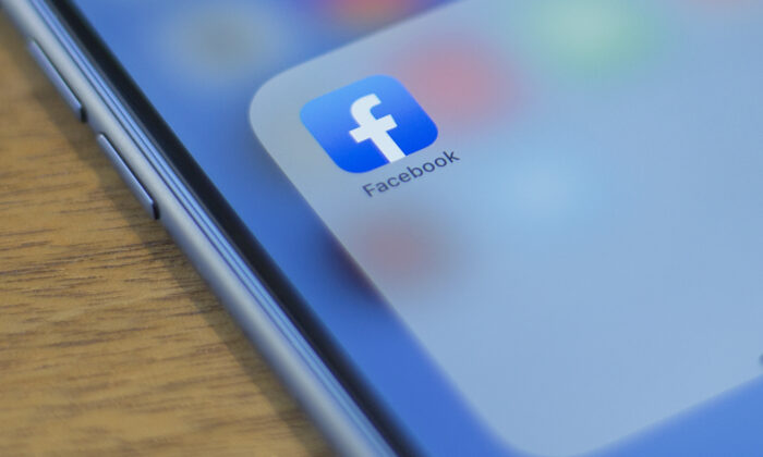 The Facebook logo is seen on a phone in this photo illustration in Washington, DC, on July 10, 2019. (Photo by Alastair Pike / AFP)        (Photo credit should read ALASTAIR PIKE/AFP/Getty Images)