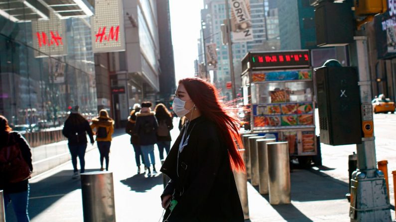 Una mujer visita Times Square con una máscara facial el 8 de marzo de 2020 en la ciudad de Nueva York, EE.UU. (KENA BETANCUR/AFP vía Getty Images)