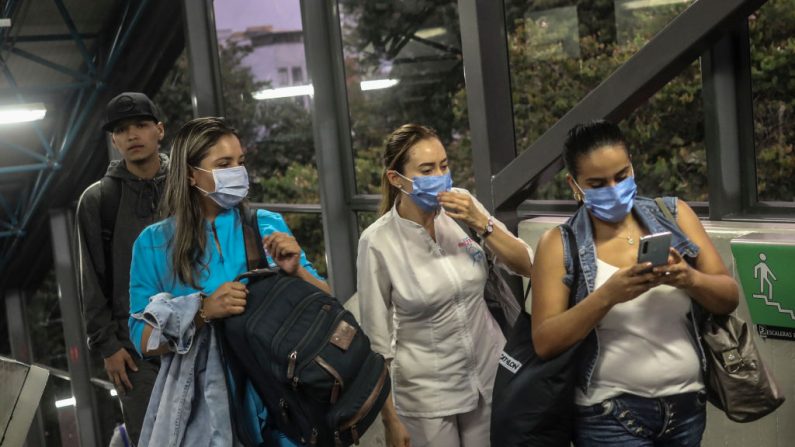 Las mujeres son fotografiadas en la estación de Metro usando máscaras faciales protectoras, como medida preventiva contra la propagación del nuevo Coronavirus (COVID-19) en Medellín, Colombia, el 13 de marzo de 2020. (JOAQUIN SARMIENTO/AFP vía Getty Images)