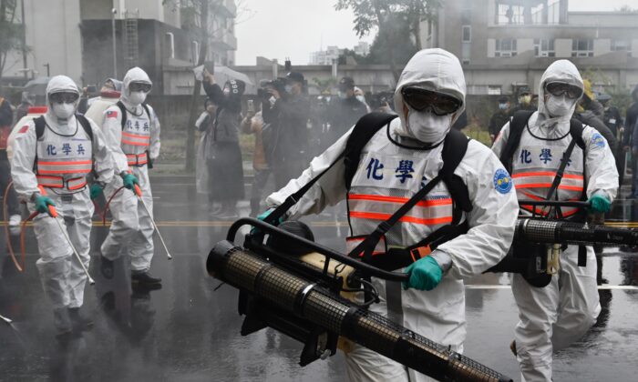 Soldados de las unidades químicas militares participan en un simulacro organizado por el gobierno de la Ciudad de Nuevo Taipei para prevenir la propagación del coronavirus COVID-19, en el distrito Xindian de Nuevo Taipei, Taiwán, el 14 de marzo de 2020. (SAM YEH/AFP a través de Getty Images)
