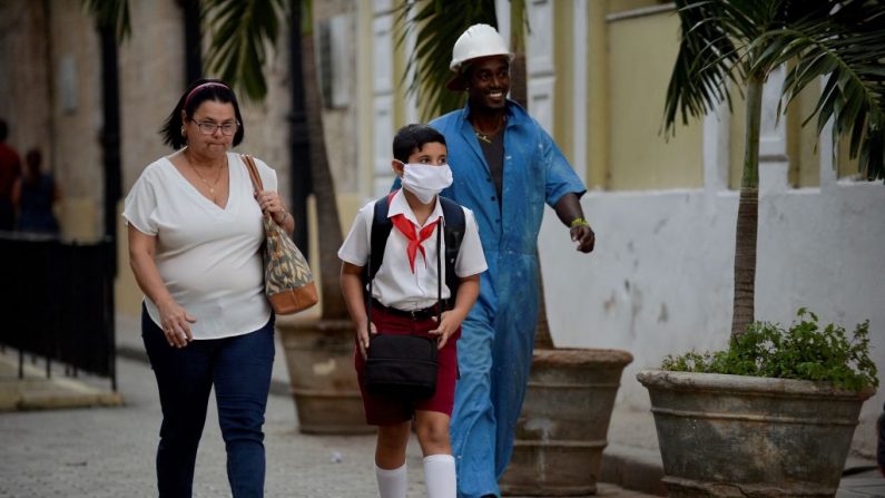 Un niño que va caminando a la escuela usa una máscara facial como medida preventiva contra el virus del PCCh, en La Habana, Cuba, el 16 de marzo de 2020. (YAMIL LAGE/AFP vía Getty Images)
