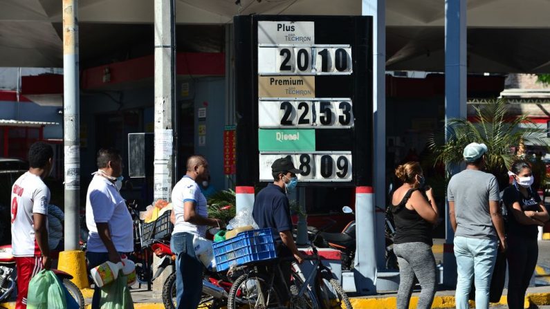 La gente hace cola para comprar aceite de queroseno en una estación de combustible en Tegucigalpa, Honduras, el 27 de marzo de 2020. (ORLANDO SIERRA/AFP vía Getty Images)