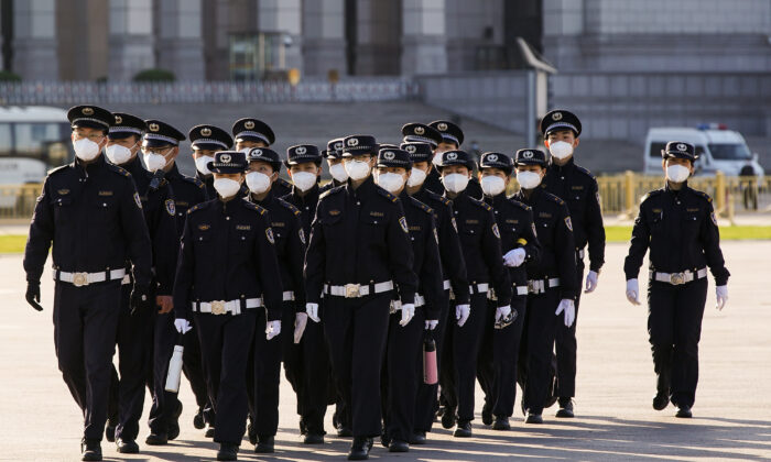 Personal de seguridad chino con mascarillas de protección marcha por la Plaza Tiananmen en Beijing, China, el 04 de abril de 2020. (Lintao Zhang/Getty Images)
