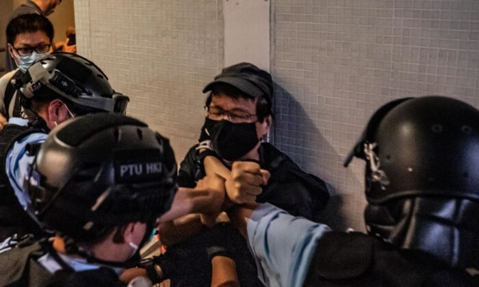 La policía detiene a un hombre en un centro comercial de Hong Kong el 26 de abril de 2020. (Anthony Kwan/Getty Images)