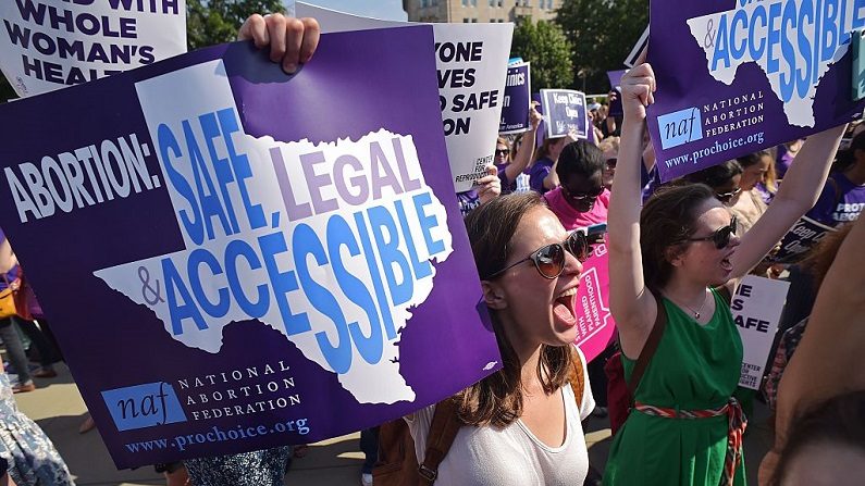 Activistas del derecho al aborto sostienen pancartas y cantan frente a la Corte Suprema de los Estados Unidos antes del fallo sobre las restricciones a las clínicas de aborto el 27 de junio de 2016 en Washington, DC. (MANDEL NGAN/AFP vía Getty Images)