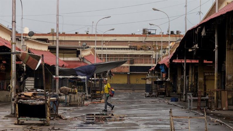 CARACAS (VENEZUELA), 29/05/2020.- Fotografía fechada el 28 de mayo del 2020 donde se observa a un hombre caminar en una jornada de saneamiento en el mercado "Las Pulgas", en Maracaibo (Venezuela). EFE/ Henry Chirinos
