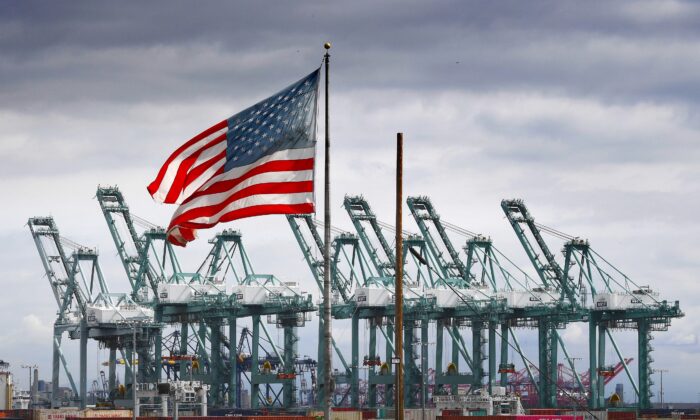 La bandera de EE.UU. ondea sobre las grúas de transporte y los contenedores en Long Beach, California, el 4 de marzo de 2019. (Mark Ralston/AFP a través de Getty Images)
