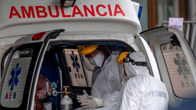 Un trabajador de la salud es atendido en una ambulancia que lleva a un paciente con síntomas del COVID-19, mientras espera ser admitido en un hospital, en Santiago (Chile), el 20 de mayo de 2020. (MARTIN BERNETTI/AFP vía Getty Images)