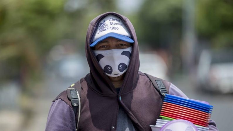 Un vendedor ambulante usa un tapabocas como medida de prevención ante el virus del PCCh durante el Día Internacional del Trabajo, en Managua (Nicaragua). EFE/Jorge Torres
