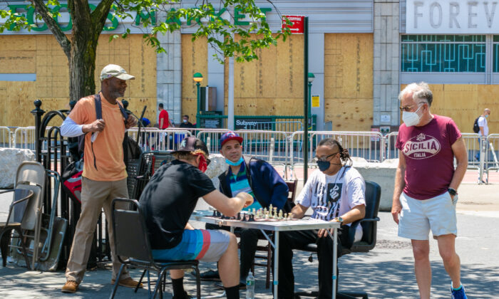 Un grupo de personas juega al ajedrez en la calle durante la pandemia de COVID-19 en Manhattan, N.Y., el 9 de junio de 2020. (Chung I Ho/The Epoch Times)