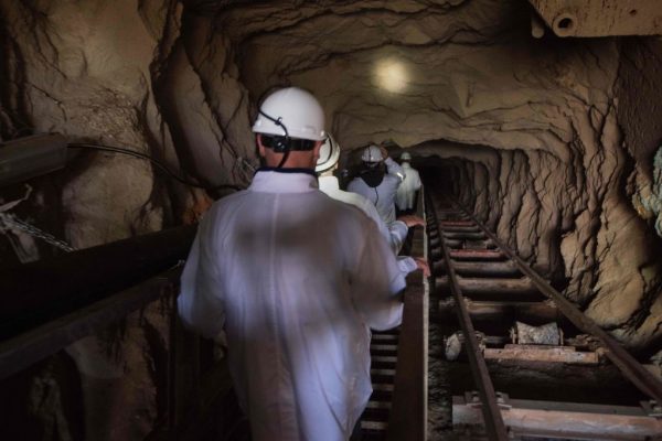 Visitors walk down the inclined shaft at Steenkampskraal (SKK) rare-earth mine on July 29, 2019, about 80Km from the Western Cape town of Vanrhynsdorp. - SKK has been confirmed as one of the highest grade deposits of rare-earth minerals in the world. The rare-earth minerals are used in the manufacture of powerful magnets, which are used in electric vehicles, wind turbines, robotics, and many other applications. The mine also produces naturally occurring radioactive thorium, which is used in medical and power generation applications. (Photo by RODGER BOSCH / AFP) (Photo credit should read RODGER BOSCH/AFP via Getty Images)