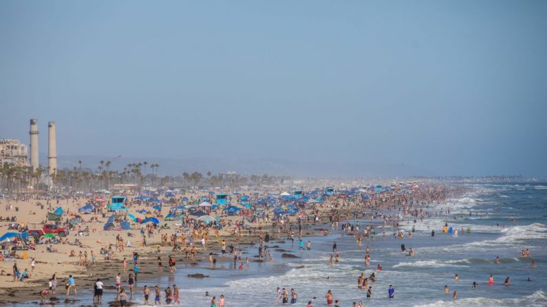 La gente disfruta de la playa en medio de la pandemia del virus del PCCh, en la playa Huntington, California, el 14 de junio de 2020. (Apu Gomes / AFP / Getty Images)

