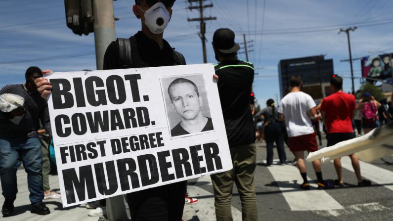  Un manifestante sostiene un cartel con una foto del ex policía de Minneapolis Derek Chauvin durante las manifestaciones tras la muerte de George Floyd el 30 de mayo de 2020 en Los Ángeles, California. (Mario Tama/Getty Images)
