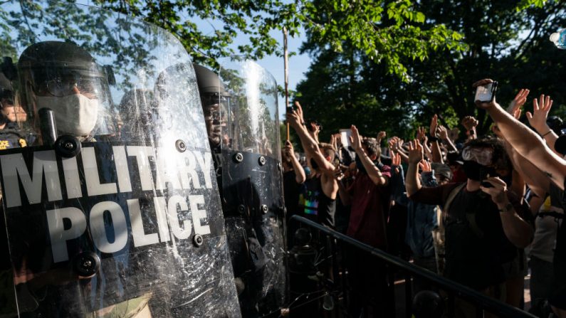 Manifestantes levantan la mano a la policía militar durante una manifestación el 1 de junio de 2020 en Washington, DC. (Joshua Roberts/Getty Images)