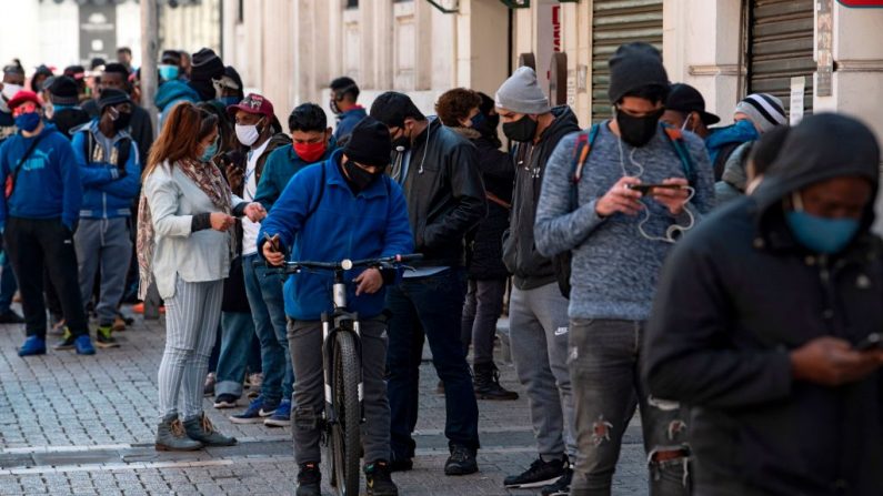 Las personas usan mascarillas mientras hacen cola para entrar en una sucursal de la oficina de fondos de pensiones para solicitar información sobre el retiro del 10% de sus depósitos en Santiago (Chile), el 24 de julio de 2020. (Foto de MARTIN BERNETTI/AFP vía Getty Images)